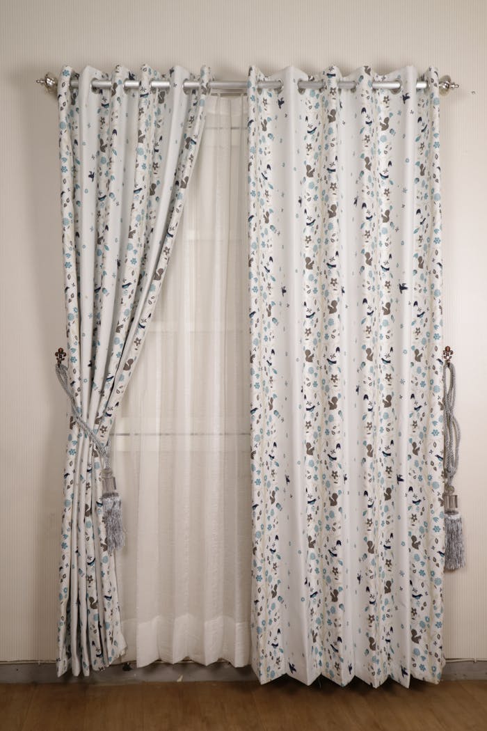 about-01 Elegant floral patterned curtains with sheer fabric on a white wall, perfect for minimalist interiors.